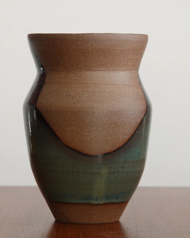 Alternate side of a vase showing glaze and exposed clay